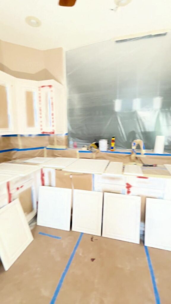 White cabinet doors and frames in a later documented condition with masking still visible