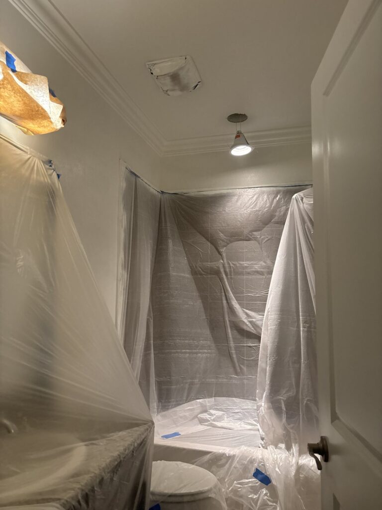 Residential bathroom protected and masked during interior painting work