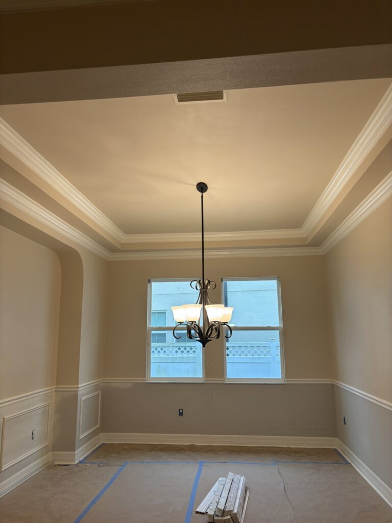 Residential dining area walls and trim during later painting progress