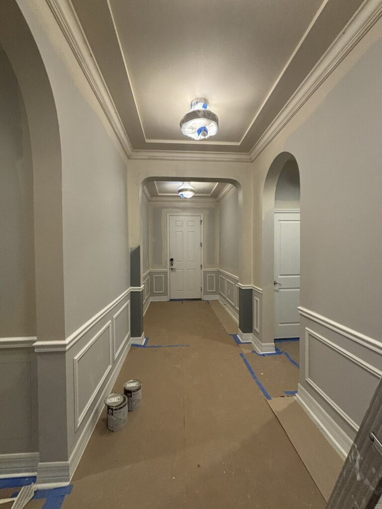 Residential hallway walls and trim during interior painting progress