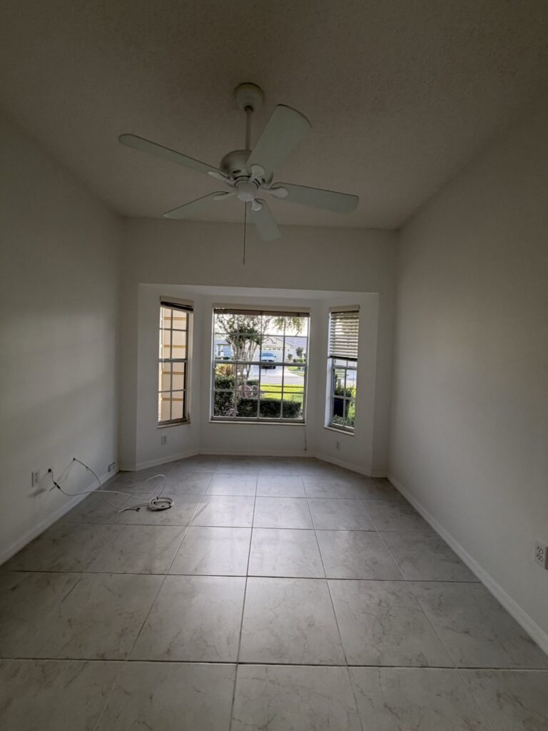 Bright residential room with neutral walls in a later documented condition