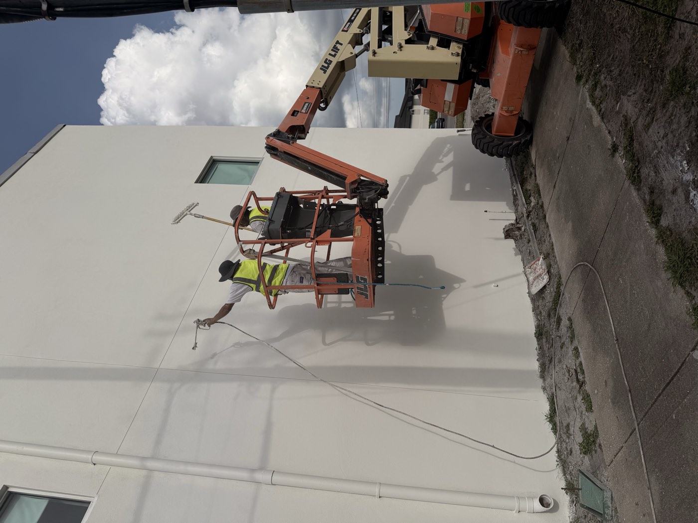 Purple Painting crew working from a lift on a Tampa Bay commercial exterior