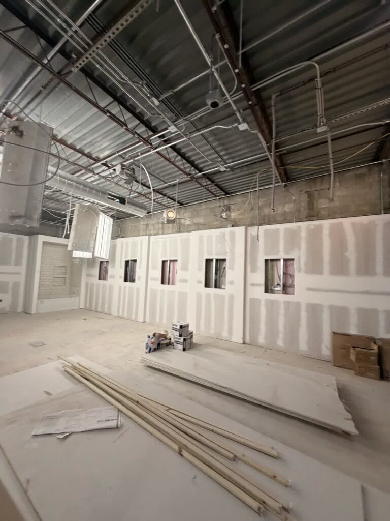 Unfinished drywall stage inside a Tampa commercial showroom