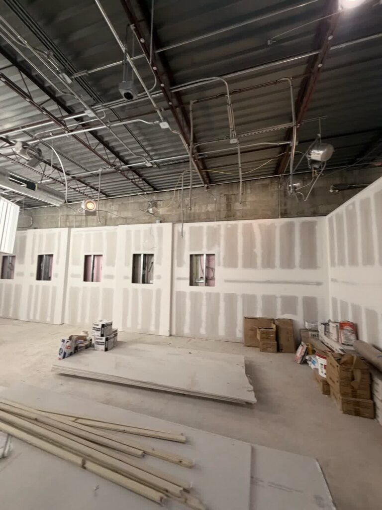 Second view of unfinished showroom walls during buildout