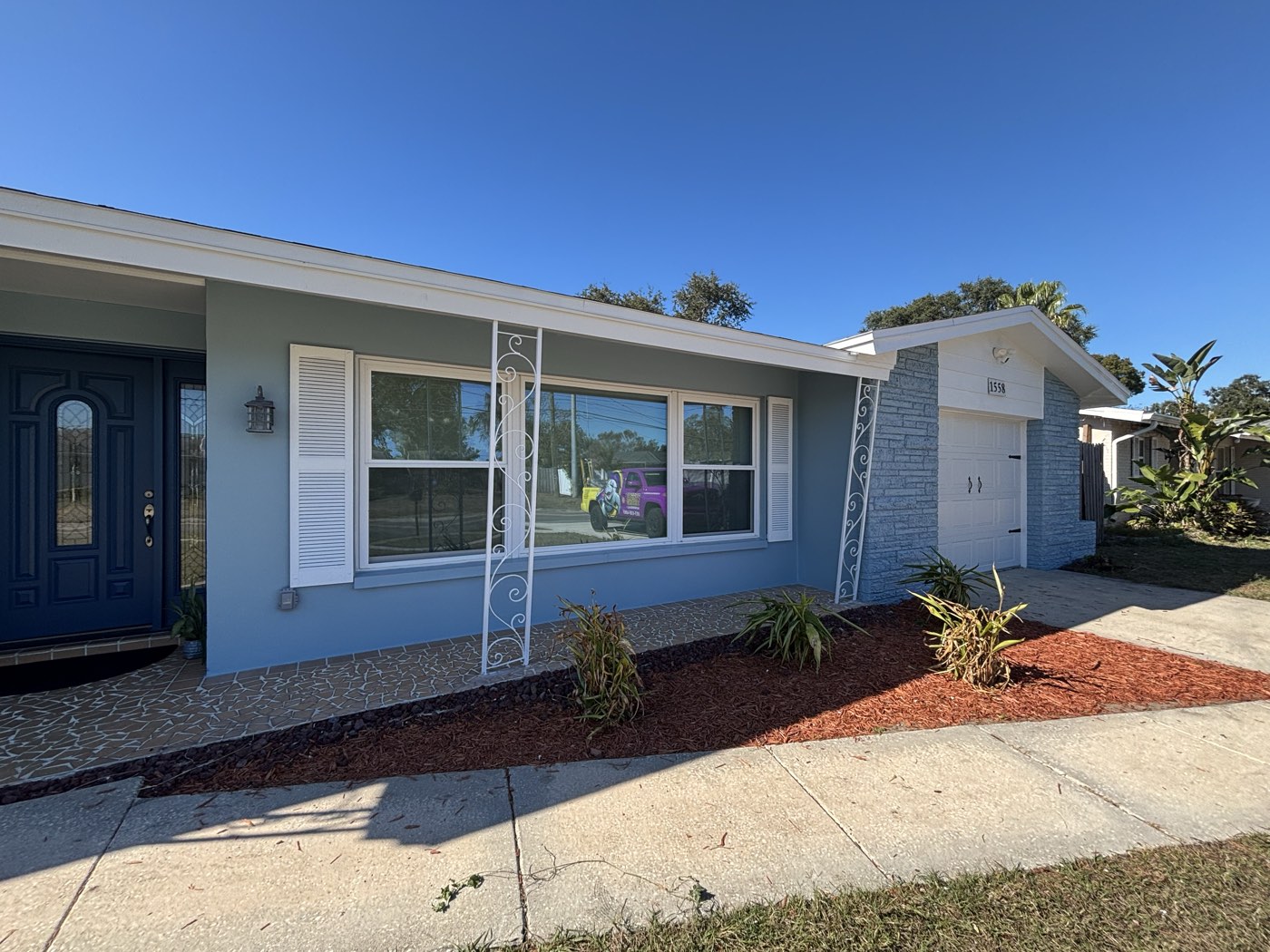 After exterior repaint of a single-story Tampa Bay home in blue-gray and white